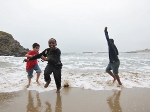 kids playing in the water on the beach